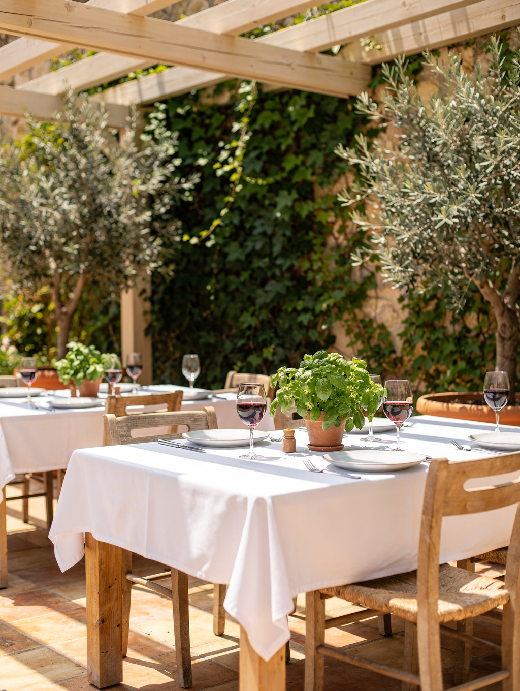 Outdoor garden terrace with lush greenery and elegant dining tables